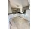 Spacious kitchen features modern tile backsplash, neutral cabinets, and tile floors at 4515 Marine Pkwy # 102, New Port Richey, FL 34652