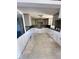 Spacious kitchen features modern tile backsplash, neutral cabinets, and tile floors at 4515 Marine Pkwy # 102, New Port Richey, FL 34652