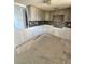 Spacious kitchen features modern tile backsplash, neutral cabinets, and tile floors at 4515 Marine Pkwy # 102, New Port Richey, FL 34652