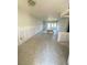 Bright living room featuring neutral tile flooring, large windows, and textured ceilings at 4515 Marine Pkwy # 102, New Port Richey, FL 34652