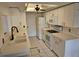 Well-lit kitchen with white cabinetry, white appliances, and tile flooring for a classic design at 4912 Enfield Ct, New Port Richey, FL 34655