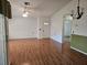 Bright living room with hardwood floors, ceiling fan, and plenty of natural light from the front door at 4912 Enfield Ct, New Port Richey, FL 34655
