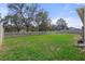 Large, fenced backyard with lush green grass, offering plenty of space for recreation and relaxation at 13822 Bee Tree Ct, Hudson, FL 34669