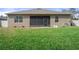 Spacious backyard with green lawn and a screened lanai, ideal for enjoying the outdoors at 13822 Bee Tree Ct, Hudson, FL 34669