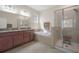 Bathroom features a double vanity, soaking tub, and glass-enclosed shower at 13822 Bee Tree Ct, Hudson, FL 34669