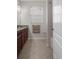 Bathroom featuring granite countertops, tile flooring, and ample lighting at 13822 Bee Tree Ct, Hudson, FL 34669