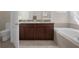 Bathroom features a granite double vanity, soaking tub, and toilet at 13822 Bee Tree Ct, Hudson, FL 34669