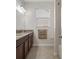 Bathroom showcasing granite countertops, tile flooring, and ample lighting at 13822 Bee Tree Ct, Hudson, FL 34669