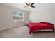 Bedroom with a ceiling fan and a window that offers plenty of natural light at 13822 Bee Tree Ct, Hudson, FL 34669