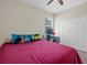 Bedroom featuring a ceiling fan, a window with natural light, and a closet at 13822 Bee Tree Ct, Hudson, FL 34669