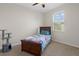 Cozy bedroom with a twin bed, a ceiling fan, and a window with bright natural light at 13822 Bee Tree Ct, Hudson, FL 34669