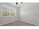 Bright bedroom featuring a ceiling fan and a large window at 13822 Bee Tree Ct, Hudson, FL 34669
