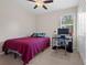 Comfortable bedroom with a ceiling fan, a window with natural light and a desk at 13822 Bee Tree Ct, Hudson, FL 34669