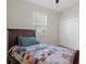 Bright bedroom featuring a twin bed, a ceiling fan, window, and closet at 13822 Bee Tree Ct, Hudson, FL 34669