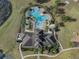 Overhead view of the community pool area, showcasing the pool, clubhouse, and surrounding landscaping at 13822 Bee Tree Ct, Hudson, FL 34669
