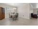 Open dining room with chandelier and view into the living room at 13822 Bee Tree Ct, Hudson, FL 34669