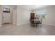 Dining room with chandelier and tile floor, connecting to the home's entrance at 13822 Bee Tree Ct, Hudson, FL 34669