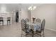 Chandelier hangs over table in dining room near breakfast bar and kitchen at 13822 Bee Tree Ct, Hudson, FL 34669