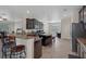 Spacious kitchen features dark cabinets, granite countertops, stainless appliances, and a center island with bar stool seating at 13822 Bee Tree Ct, Hudson, FL 34669