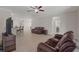 Spacious living room with tile floors, comfortable furniture, and a glimpse of the open kitchen and hallway at 13822 Bee Tree Ct, Hudson, FL 34669