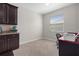 Bright office space features a large window, desk area, and cabinetry for storage at 13822 Bee Tree Ct, Hudson, FL 34669