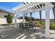 Outdoor patio area with a pergola, table, and chairs, perfect for relaxing and entertaining at 13822 Bee Tree Ct, Hudson, FL 34669