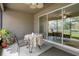 Relaxing screened patio with a table setting and a view of the outdoors at 13822 Bee Tree Ct, Hudson, FL 34669
