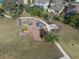 Aerial view of the community playground and surrounding green space, with various play structures at 13822 Bee Tree Ct, Hudson, FL 34669