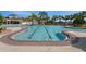 Community pool featuring a lap lane, a spa, and comfortable lounge chairs for residents to enjoy at 13822 Bee Tree Ct, Hudson, FL 34669