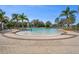 Zero entry community pool area with palm trees, fountains, lounge chairs, and a splash pad at 13822 Bee Tree Ct, Hudson, FL 34669