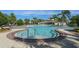 Community pool with a spa and plenty of seating, perfect for relaxing and enjoying the sunshine at 13822 Bee Tree Ct, Hudson, FL 34669
