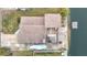 Aerial shot of a charming home featuring a large roof, spacious deck, and dock on a tranquil canal at 3265 Gardenia Dr, Hernando Beach, FL 34607