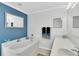 Beautiful bathroom featuring a soaking tub, large vanity, modern finishes, and blue accent wall at 4332 Lamson Ave, Spring Hill, FL 34608