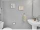 Bathroom featuring a pedestal sink, neutral paint, framed art, and modern fixtures at 4332 Lamson Ave, Spring Hill, FL 34608