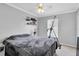 Neutral bedroom with a window, ceiling fan and minimalistic decor at 4332 Lamson Ave, Spring Hill, FL 34608