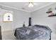 View of a neutral bedroom with a window, ceiling fan and minimalistic decor at 4332 Lamson Ave, Spring Hill, FL 34608