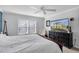Clean bedroom features a ceiling fan, large window for natural light, and neutral decor at 4332 Lamson Ave, Spring Hill, FL 34608