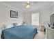 Bright bedroom featuring neutral walls, ceiling fan and a large window providing lots of natural light at 4332 Lamson Ave, Spring Hill, FL 34608