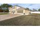 Two-story home featuring an attached two-car garage, well-maintained lawn, and mature landscaping at 4332 Lamson Ave, Spring Hill, FL 34608