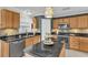 Modern kitchen with stainless steel appliances, granite countertops, tiled backsplash, and ample wood cabinetry at 4332 Lamson Ave, Spring Hill, FL 34608