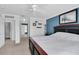 Bright main bedroom features a ceiling fan, stylish accent wall, and updated furniture at 4332 Lamson Ave, Spring Hill, FL 34608