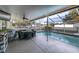 View of the pool and patio with a ceiling fan and dining seating at 4332 Lamson Ave, Spring Hill, FL 34608