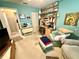 Cozy bedroom with an organized workspace, blue walls, and comfortable seating at 8111 Merrimac Dr, Port Richey, FL 34668