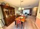 Dining area with hutch, dining table, and view into a cozy living room at 8111 Merrimac Dr, Port Richey, FL 34668