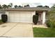 Charming single-story home with a well-maintained lawn and a two-car garage at 8111 Merrimac Dr, Port Richey, FL 34668
