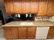Kitchen featuring granite countertops, double sink, and wood cabinetry at 8111 Merrimac Dr, Port Richey, FL 34668