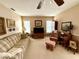 Traditional living room with neutral tones and a plush sofa for relaxing and entertaining at 8111 Merrimac Dr, Port Richey, FL 34668