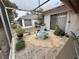 Enclosed patio with decorative fountain, gravel, and stepping stones at 8111 Merrimac Dr, Port Richey, FL 34668