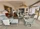 Relaxing screened patio with ceiling fan, table, and comfortable seating at 8111 Merrimac Dr, Port Richey, FL 34668