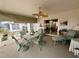 Comfortable covered patio with fan, table and seating for outdoor relaxation at 8111 Merrimac Dr, Port Richey, FL 34668